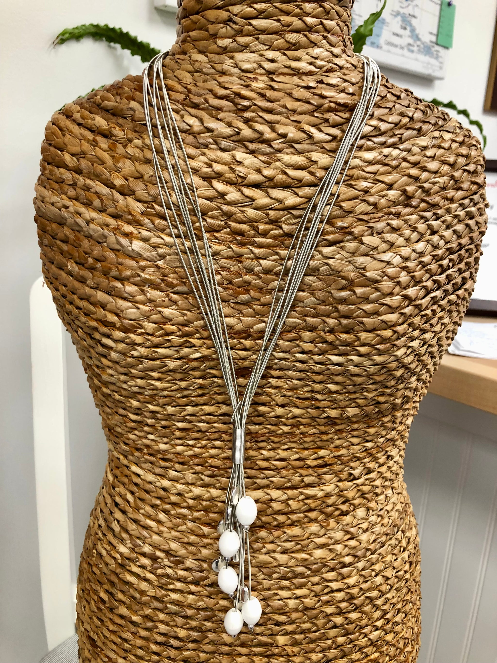 S102D - Silver wire lariat necklace with white porcelain beads