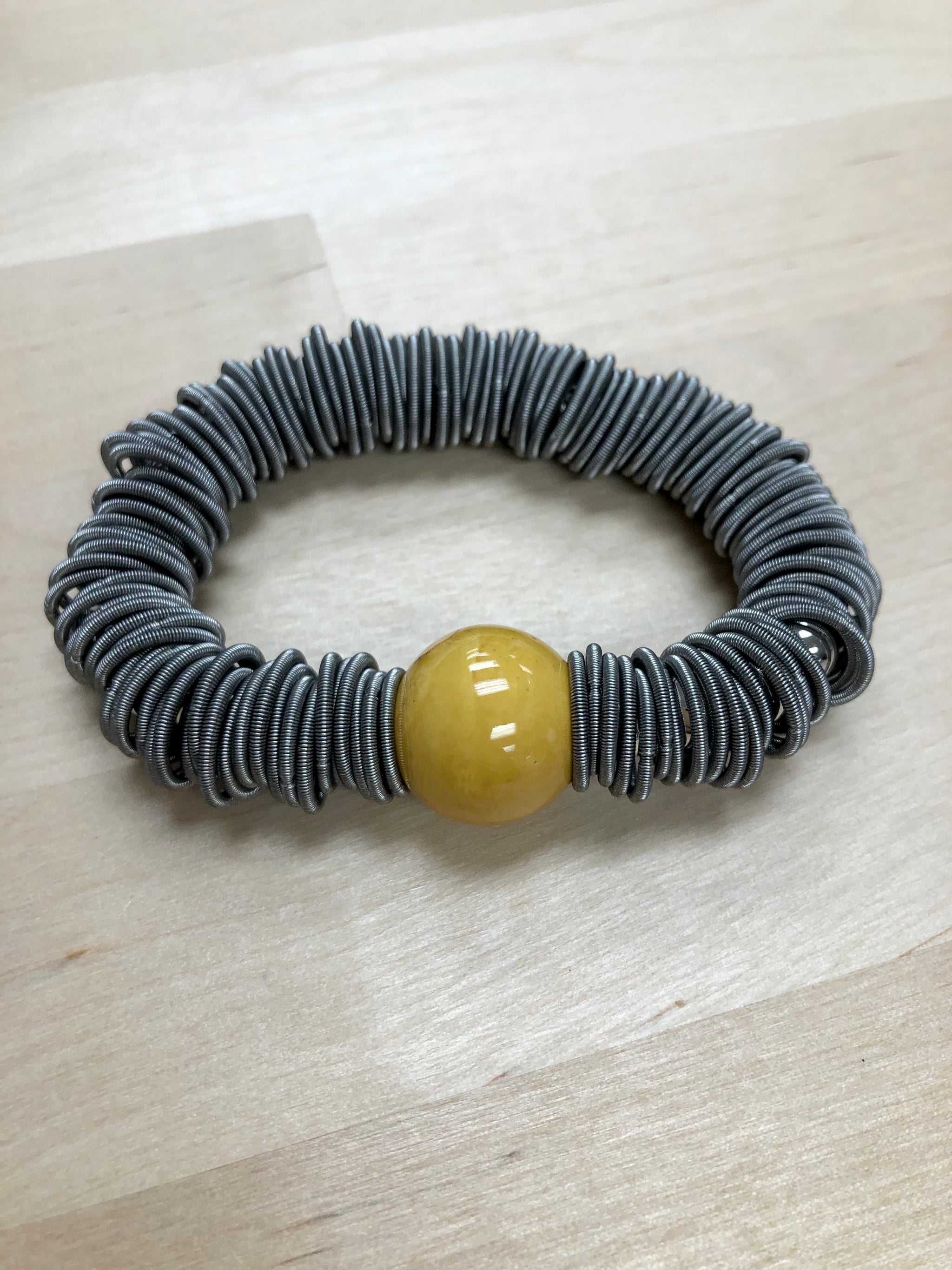 S104BR - Slate & spring ring bracelet with yellow porcelain bead